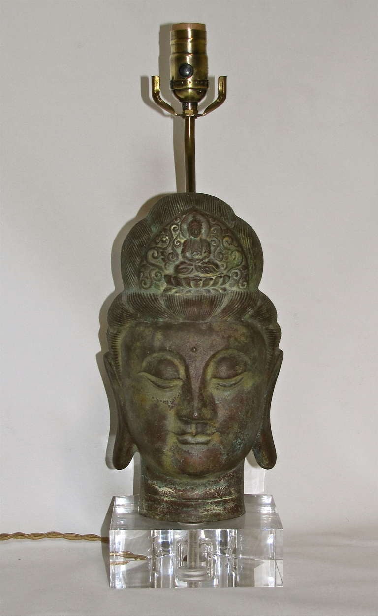 Very decorative bronze patinated Quan Yin head table lamp mounted on custom acrylic base with twisted french cord. Newly wired.