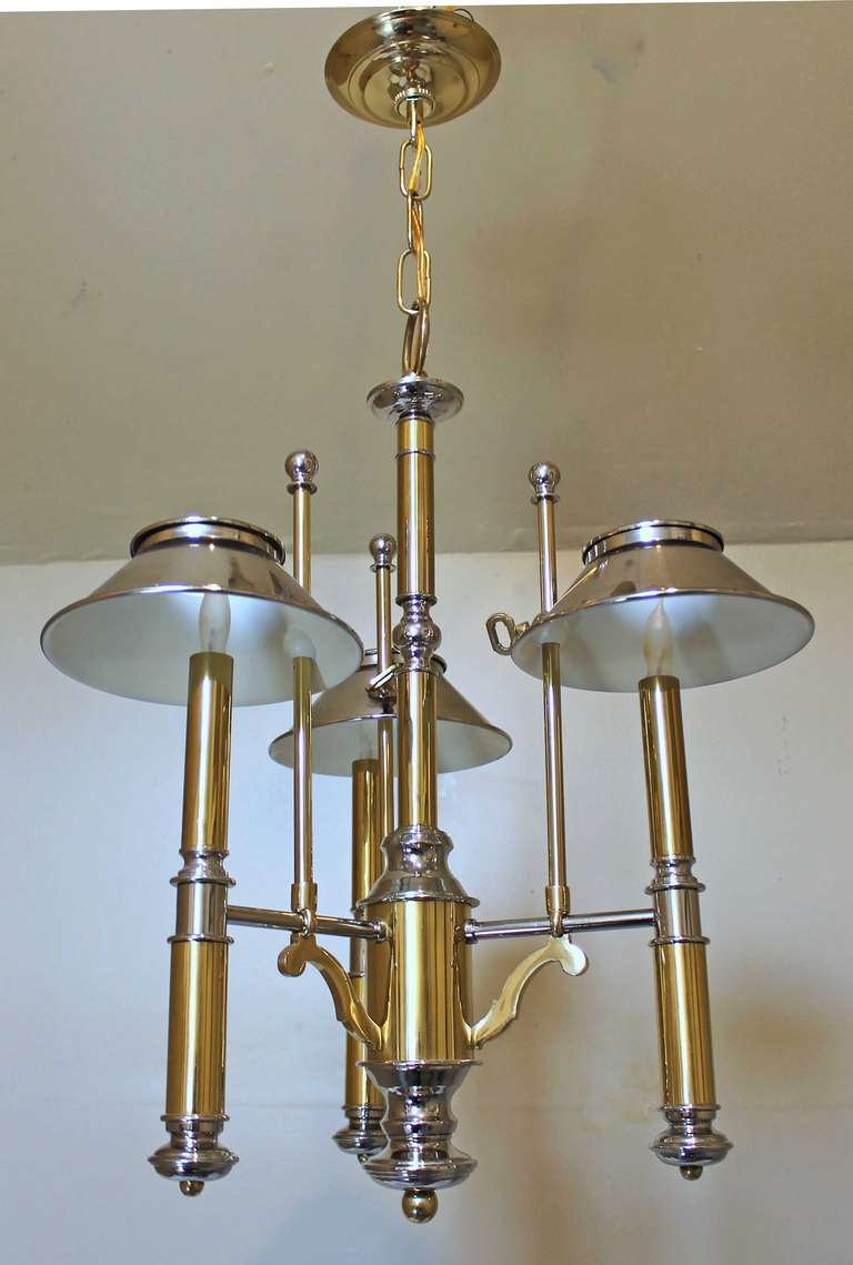French bouillotte style chandelier or pendant light in polished brass and nickel by Lightolier. Three candle arms with adjustable height shades use B or candelabra base bulbs. Wired for US.

Fixture alone is 17