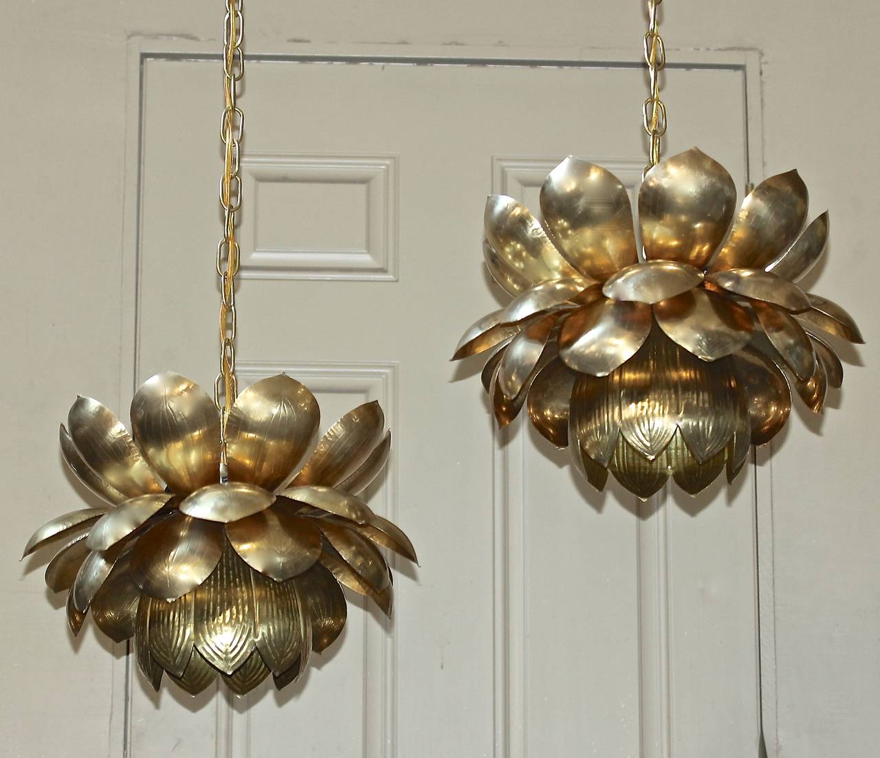 Pair of large brass lotus blossom light pendants or chandeliers made by the Feldman Company, Los Angeles. The lower light uses 1 - 60 watt max 