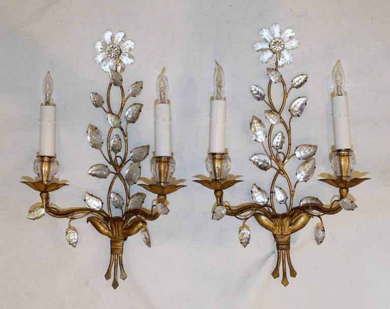 Pair of 1940s Bagues gilt metal floral motif two-light wall sconces. Each sconce uses 2-40 watt candelabra base bulbs. Newly wired.