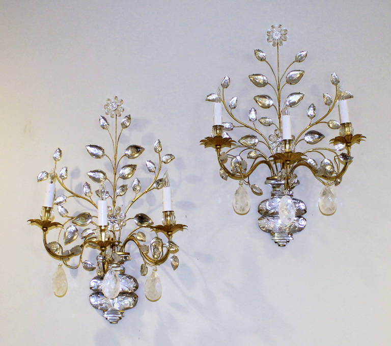 Pair of large three arm gilt iron and crystal wall sconces with crystal leaf and urn elements and three large rock crystal pendalogues by Maison Bagues, Paris. Bagues catalogue style #20.