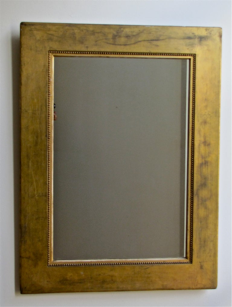 Handsome Charles X style giltwood wall mirror. Water gilt with black bole under coat with 23-karat gold leaf.

 