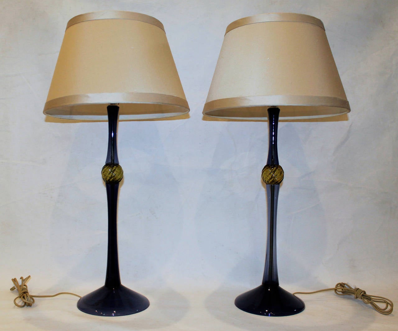 Pair of Italian blue glass lamps with absynthe green spheres by John Hutton for Donghia, signed. The pair of custom fabric shades are included. Nickel plated hardware with full rane dimmer sockets and French style rayon cords, newly wired. Overall
