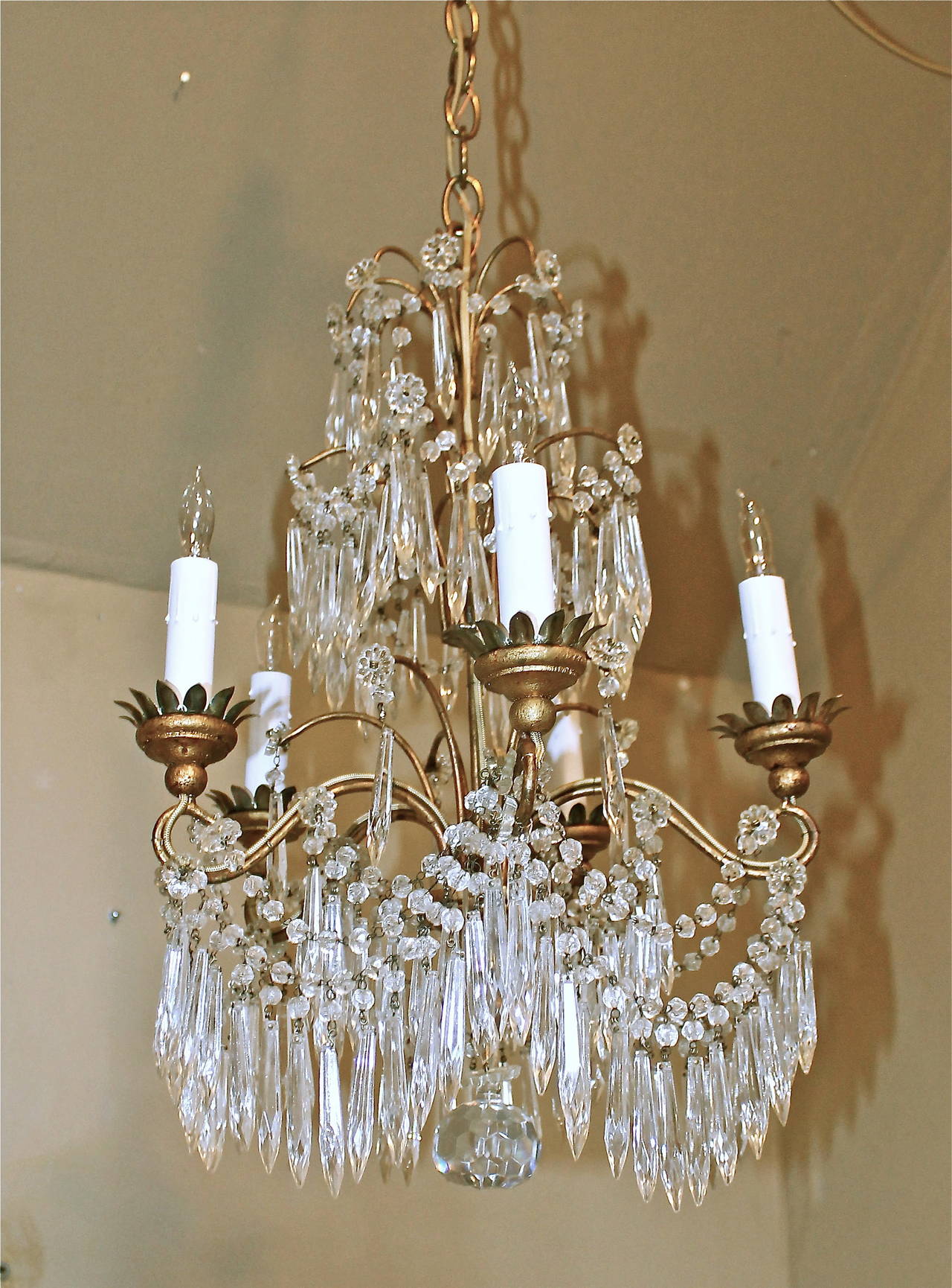 Italian Gilt wood and iron 5 light chandelier with crystal swags and drops, Rewired. Uses 5 - 40 watt candelabra base size bulbs. Perfect size for entry or powder bath.
Chandelier size 20