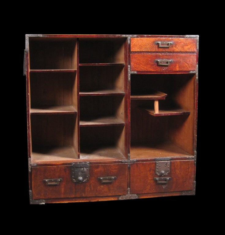 Book chest with display shelves with iron details and fan shaped door handles.