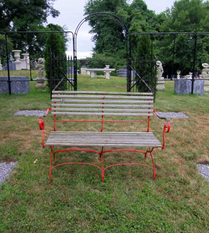 European Wrought Iron Bench, newly painted red with replaced wooden slats that have weathered nicely.  (We have a pair, but the second has not been refurbished.)
