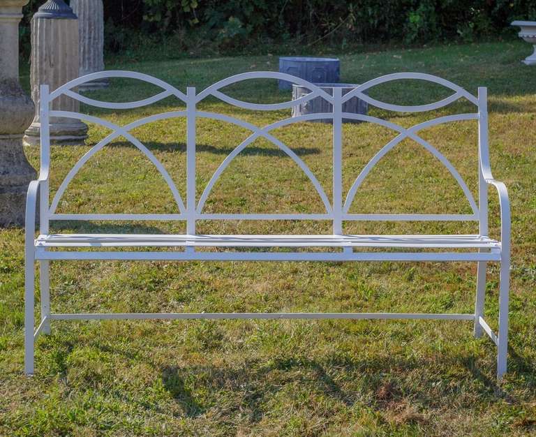 Vintage pair of wrought iron benches designed in the Sheraton style and imported from England.