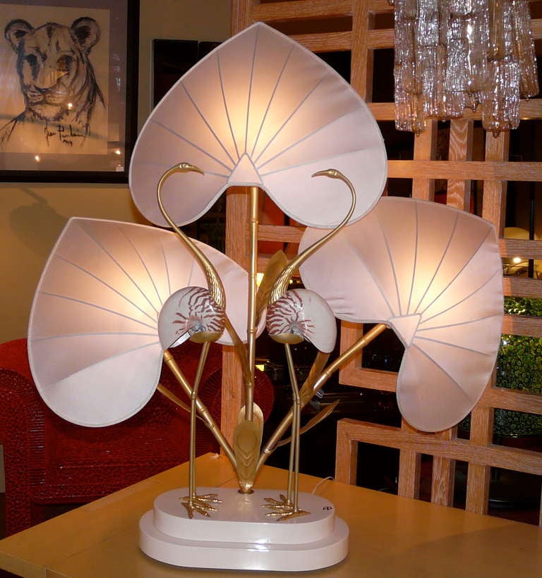 Extraordinary table lamp by Antonio Pavia made of two nautilus figuring the body of golden bronze cranes on a lacquered base.Lampshades are in silk.
One have some dust marks (see picture 5).
Total size with lampshades : 104 cm(41 in) x 100cm(39