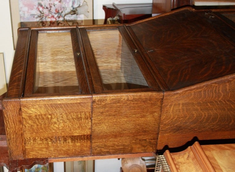 This is a high end tiger oak lawyer's bookcase by Michigan manufacturer Humphrey Widman. The cabinet has three glass enclosed shelves for book sof 10