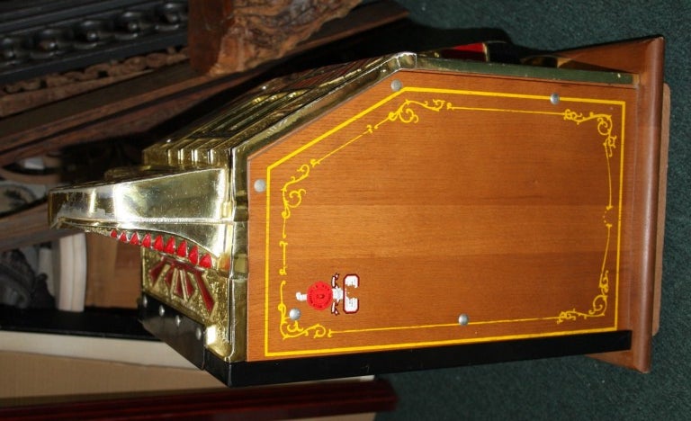 This is a reconditioned War Eagle Slot Machine amde by the Mills Company. It is in fine running condition. It takes quarters to play. It pays the correct payoffs up to 20 quarters as shown on its payoff scale. It has been restored with parts that