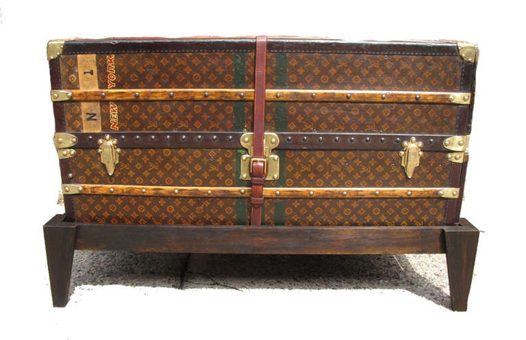 Louis Vuitton Wardrobe c.1910 in excellent antique condition.  Louis Vuitton monogram canvas exterior trimmed with lozine, brass, and wood.  Interior fully lined in yellow canvas and features 6 drawers on one side and a clothes hanger on the other.