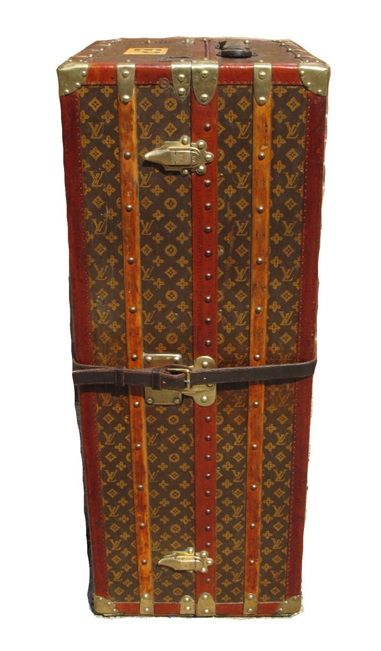 Louis Vuitton monogram papillion wardrobe c1915 in excellent condition.  Monogram canvas exterior trimmed with wood, lozine, and brass hardware.  Yellow canvas lined interior with 6 drawers, hangers, ironing board, clothing separator, and travel