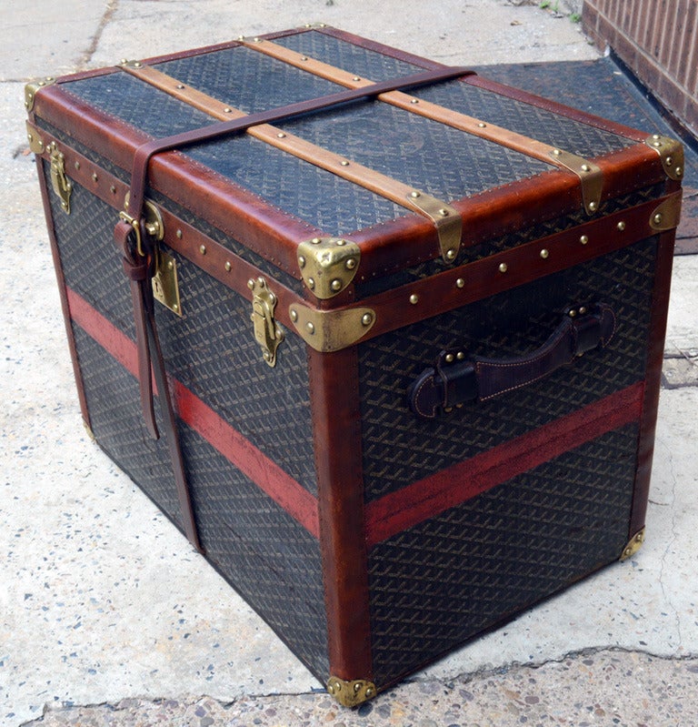 Antique Goyard half trunk in excellent antique condition. Signature Goyard monogram exterior trimmed with lozine and bronze hardware. Front triple latch closure opens to a gorgeous interior refurbished with red stripe canvas. This piece is in