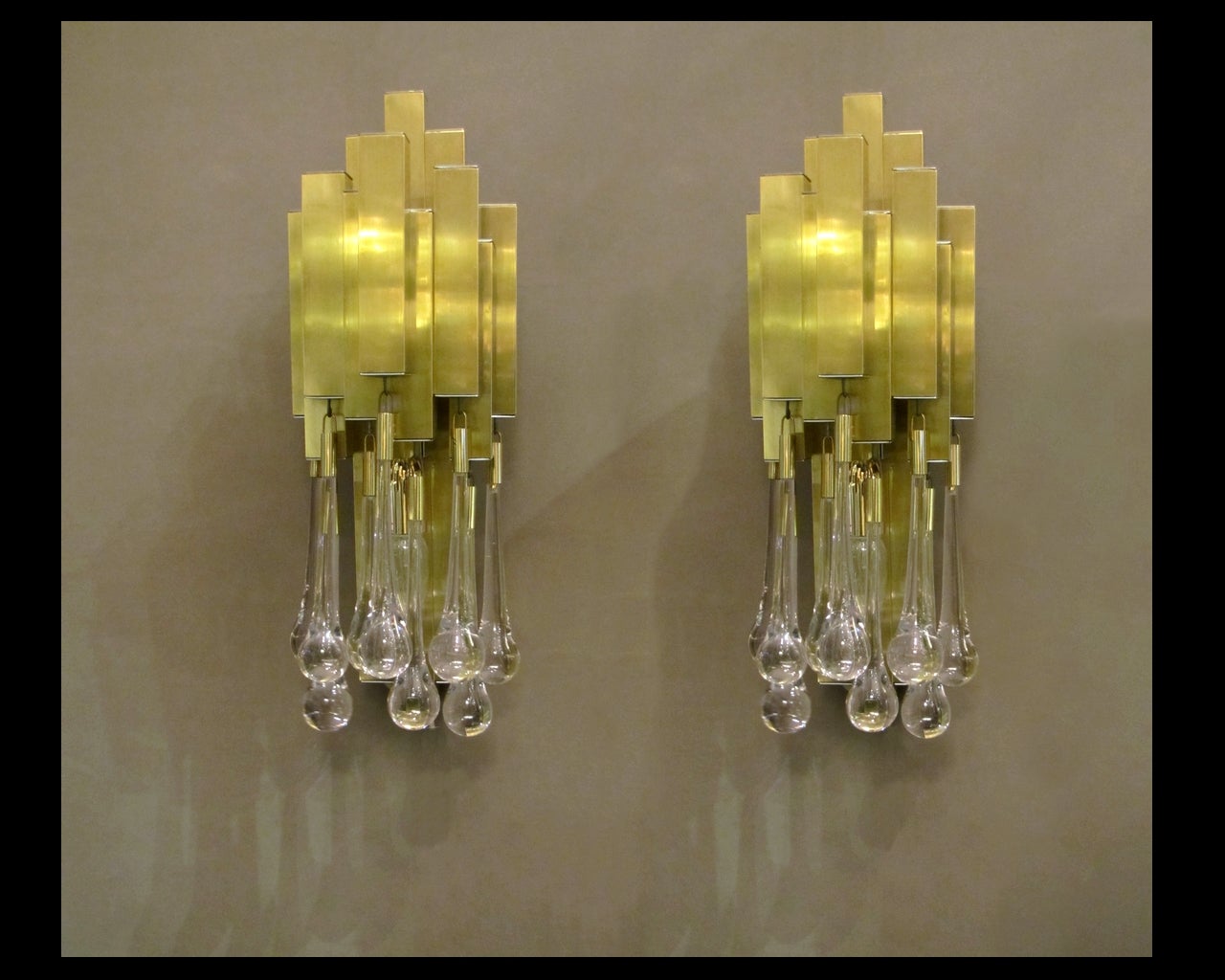 Gilded and chromed metal. Clear glass drops. Two lights by sconce.

Two pairs available. Price for one pair.