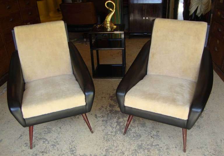 Pair of amusing 1950'sarmchairs, original covered in black leatherette and imitation lamb plush.