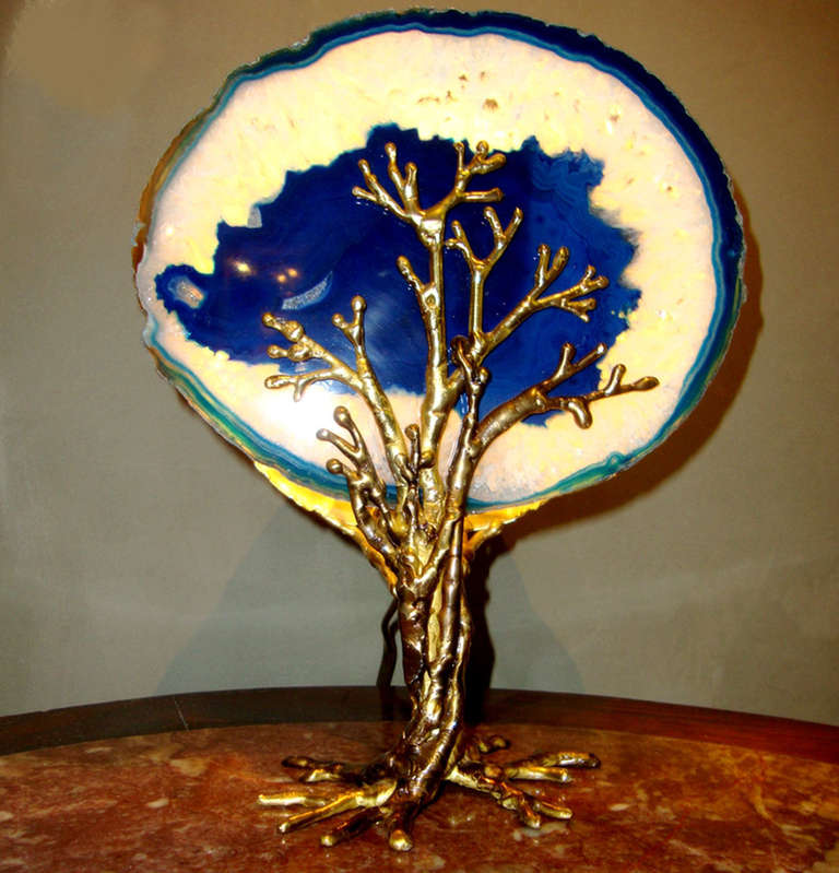 Delicate lighting sculpture by Isabelle Masson-Faure, representing a tree whose leaves are a large slice of blue agate embedded in branches and trunk in worked brass. Unique piece. Signed.