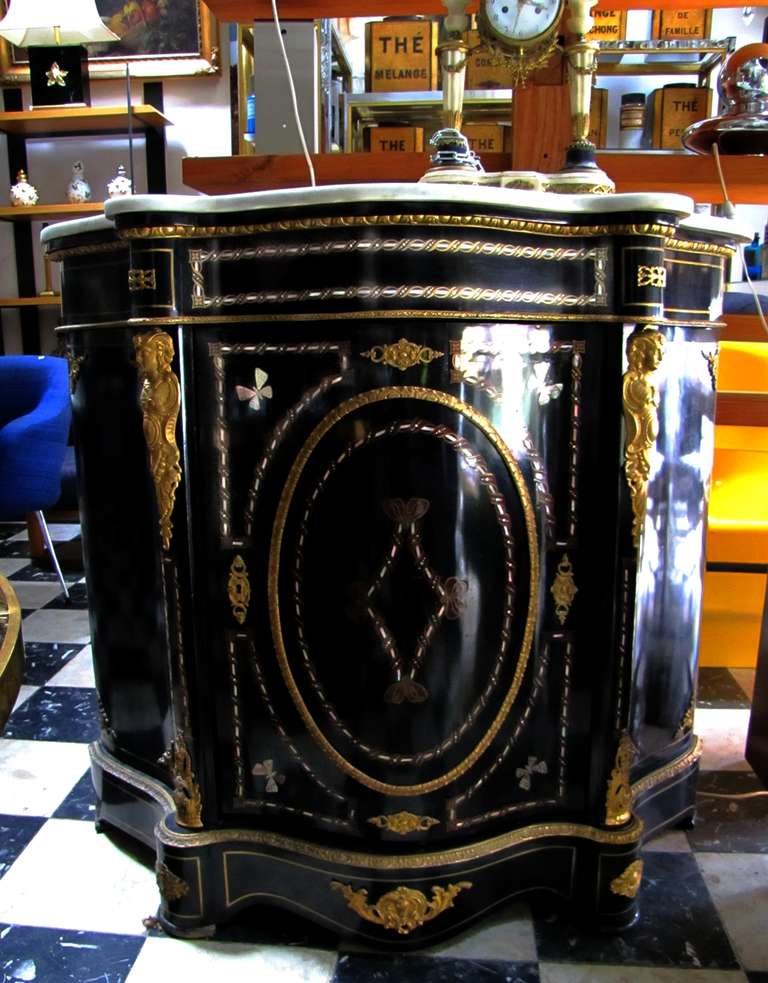 Nice Napoleon III cabinet in ebonized wood, with rosewood, brass and mother of pearl inlays. Bronze ornamentation. Original top on white Carrara marble. Interior in varnished mahogany.