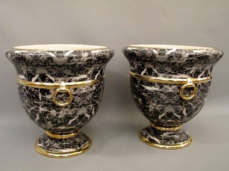 Two important cache-pots made in Italy for Christian Dior around 1980. In glazed earthenware in imitation of marble inlay with gilt fillets. Signed.