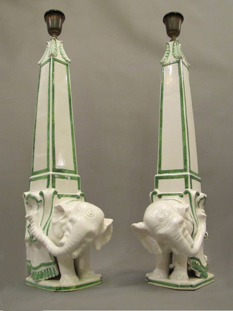 Elephant shaped lamps made of white enamelled faience with green decoration.