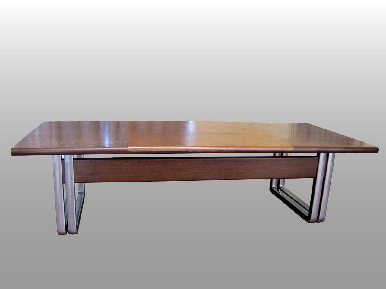 Large 1970s Italian desk by Osvaldo Borsani, with base in chrome metal and black leather clad interior. Two small drawers in the front; top surface in wenge and leather.