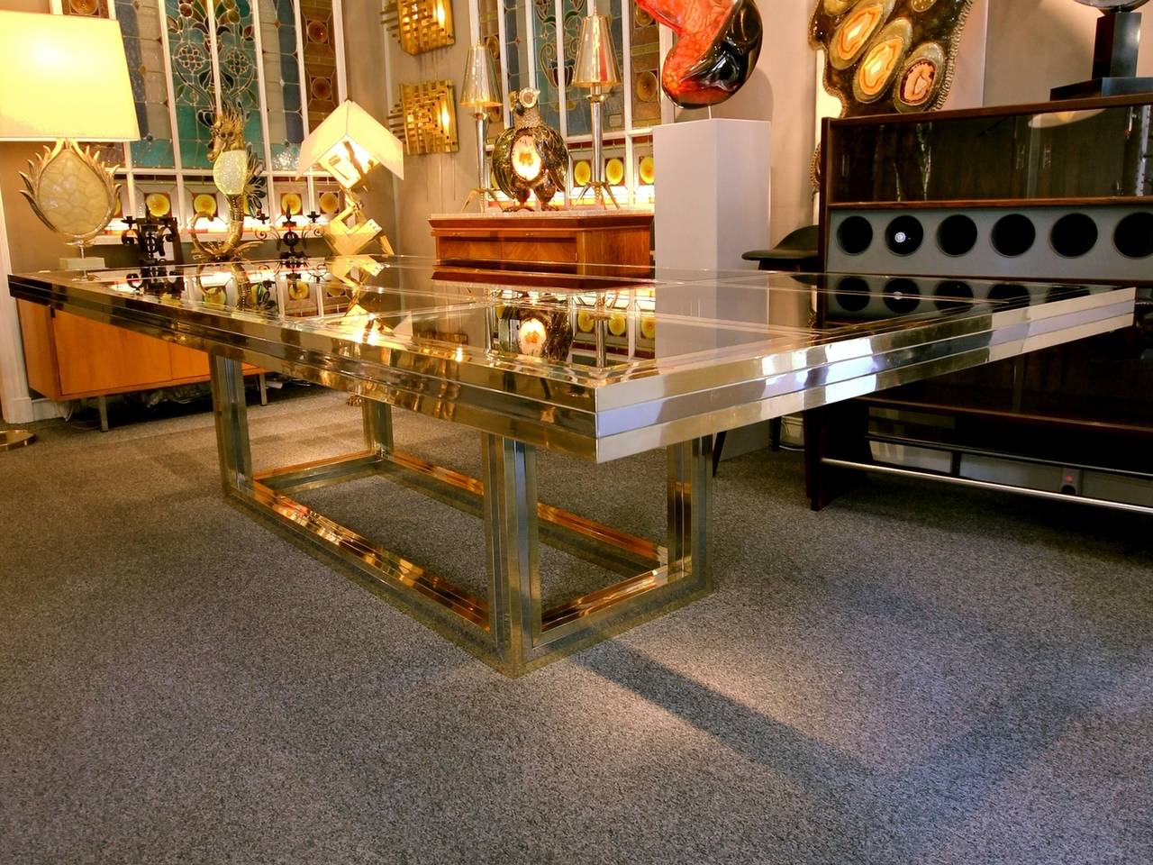 Wonderful large dining or conference table in polished brass and chromed metal, with beveled and tinted glasses. Wonderful quality and design.