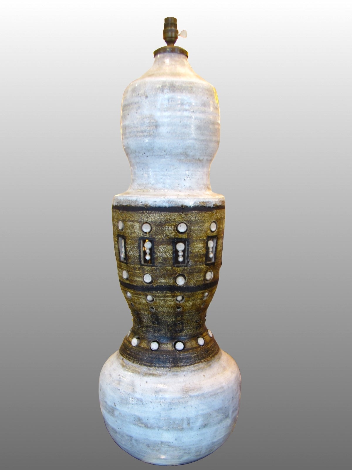 Beautiful large lamp base in enameled stoneware, with scarification and lighting in the interior of the base.

George Pelletier was born in Brussels in 1938.