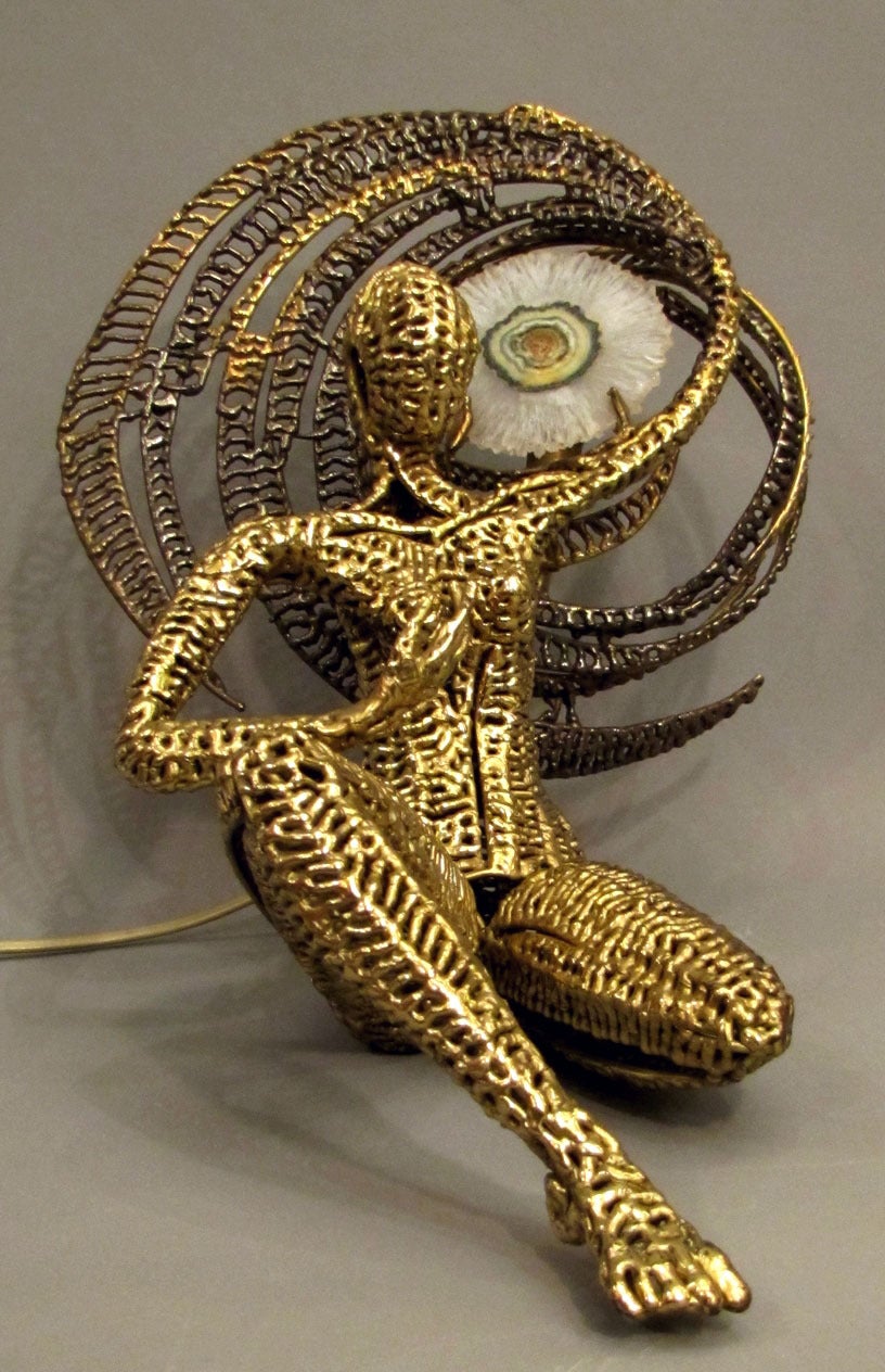 Delicate luminous sculpture depicting a woman wearing the sun, handmade in polished and patinated brass, with a very rare variety of carved agate. Unique piece, signed.