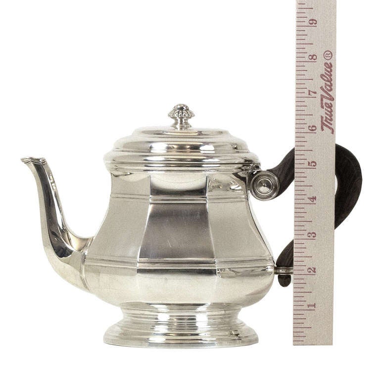 This fine French tea and coffee service, by the renowned Parisian firm Puiforcat, has a refined decorative form that easily mixes with traditional or contemporary décor. Consisting of a coffee pot, tea pot, creamer and covered sugar bowl, this