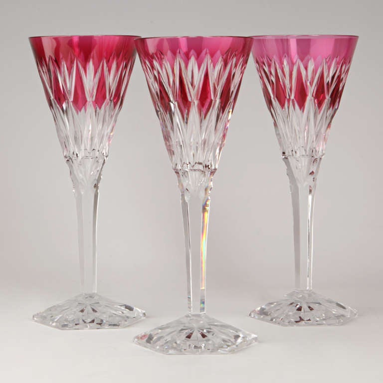 This set of 12 cut to clear ruby wine glasses features the superb style and quality characteristic of Val St. Lambert. Made in the fifties, the style is a complex twist combining their classical patterns with a dash of Deco.
 
Remarks by Lawrence