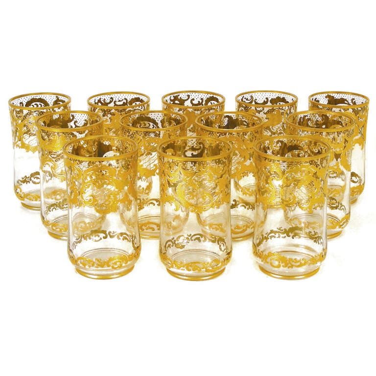 Circa 1890s, Josephine Hutte, Germany.  This set of twelve 4 1/2  inch tall tumblers by the renowned German firm of Josephine Hutte is decorated with an ornately rocaille raised gilded design. Perfect for water, wine or as an occasional canteen,