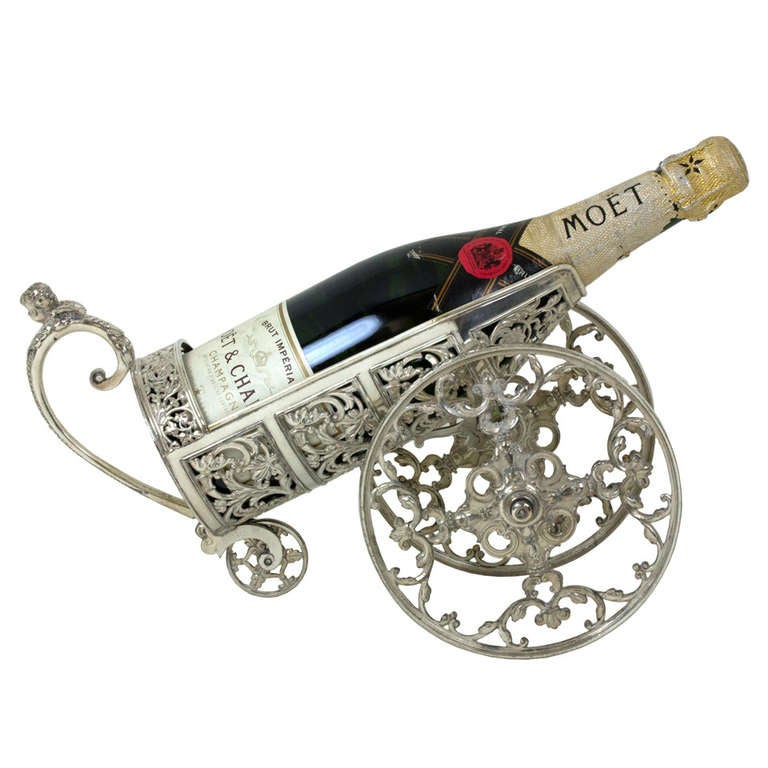 Circa 1900, silverplate, German, possibly WMF.  This wonderful Victorian table accessory is a baroque taste silverplate carriage for your champagne cannon (bottle). Perfect to decorate a wine cellar, credenza, or bar. Excellent condition.

Remarks