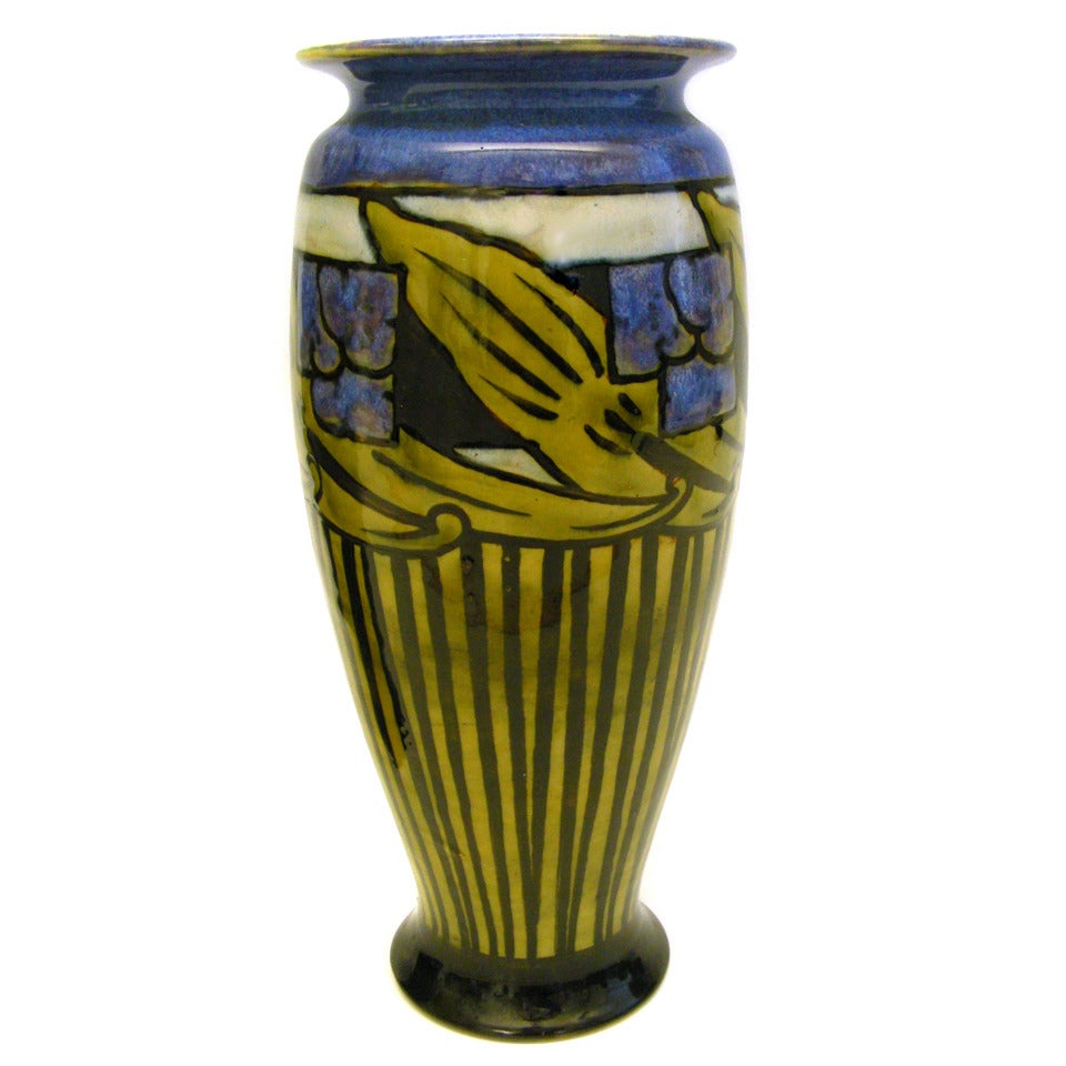 Royal Doulton, England, circa 1920s. De-accessioned from the Harriman-Judd collection and sold at Sotheby's, these strikingly decorated pair of Royal Doulton Art Deco vases feature urbane stylized foliate and floral designs. The lush blue in the