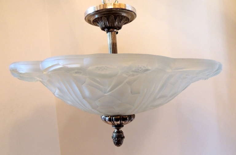 A wonderful French Art Deco silvered bronze and art glass flush mount fixture set with four lights inside.