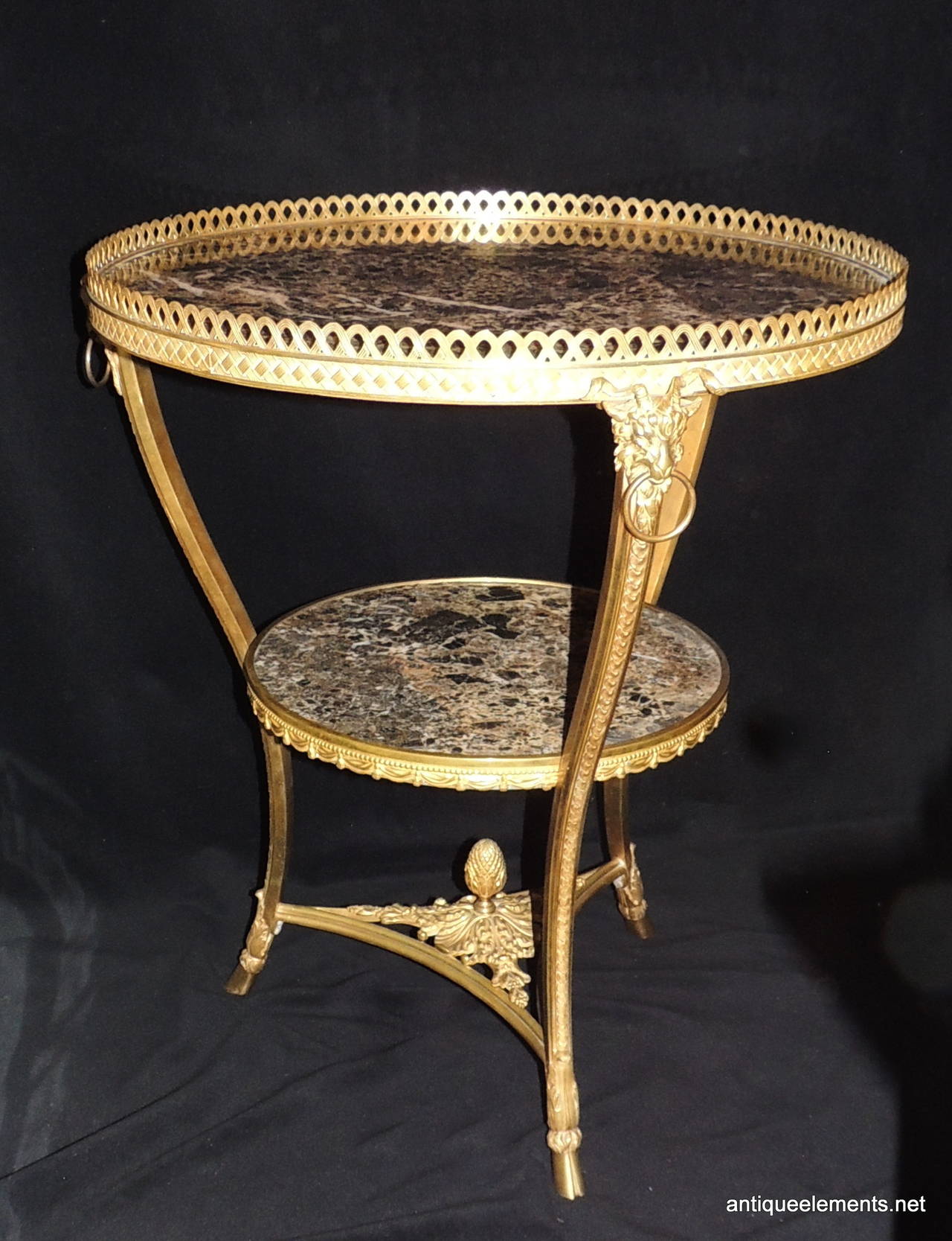This beautiful Gueridon table has everything going for it. From the wonderful dore bronze detailing with braided engraving and pierced trim surrounding each level to the beautiful acorn center at the bottom on a bed of leaves. The three legs are