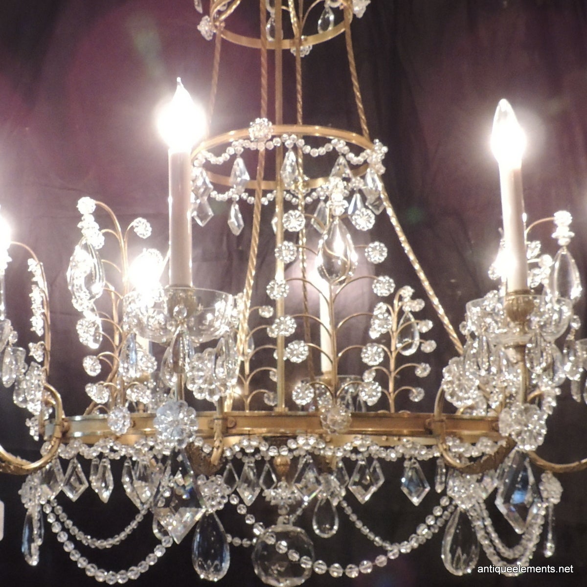 This elegant French Baltic style early 20th century eight-light chandelier will be a wonderful addition to your home or business. An elegant French Bronze and Crystal chandelier that is detailed starting with the crown of crystal drops, the