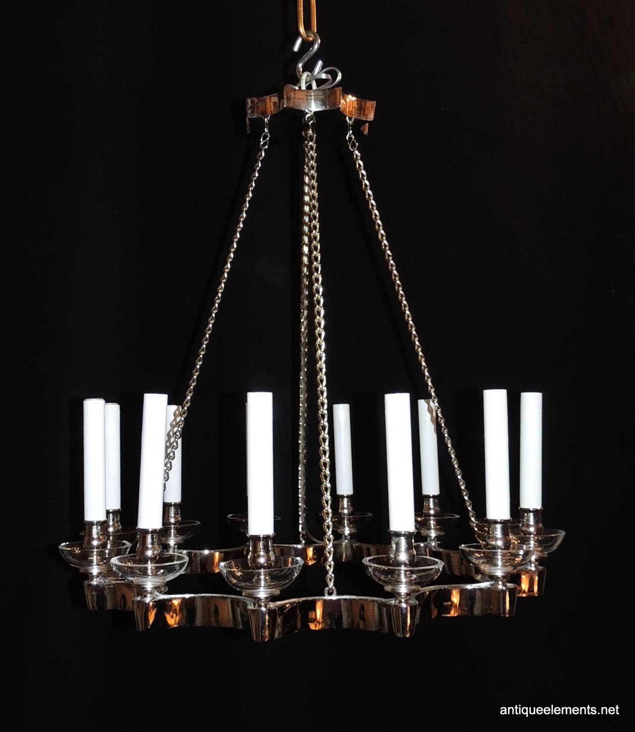 A Mid-Century Modern chrome / nickel fixture that is simply elegant. This pendant style chandelier with twelve lights is a wonderful open soft circular shape that is supported by four silver chains and a wonderful chrome canopy. Each of the