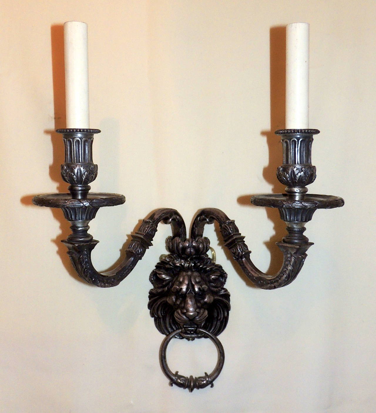 Wonderful pair of silvered bronze lion head sconces with rings. Beautiful strong detail everywhere you look. From the arms to the cups, the majestic lion's face and even detail on the hanging rings. Marked style 108 on back, very faint marks, but