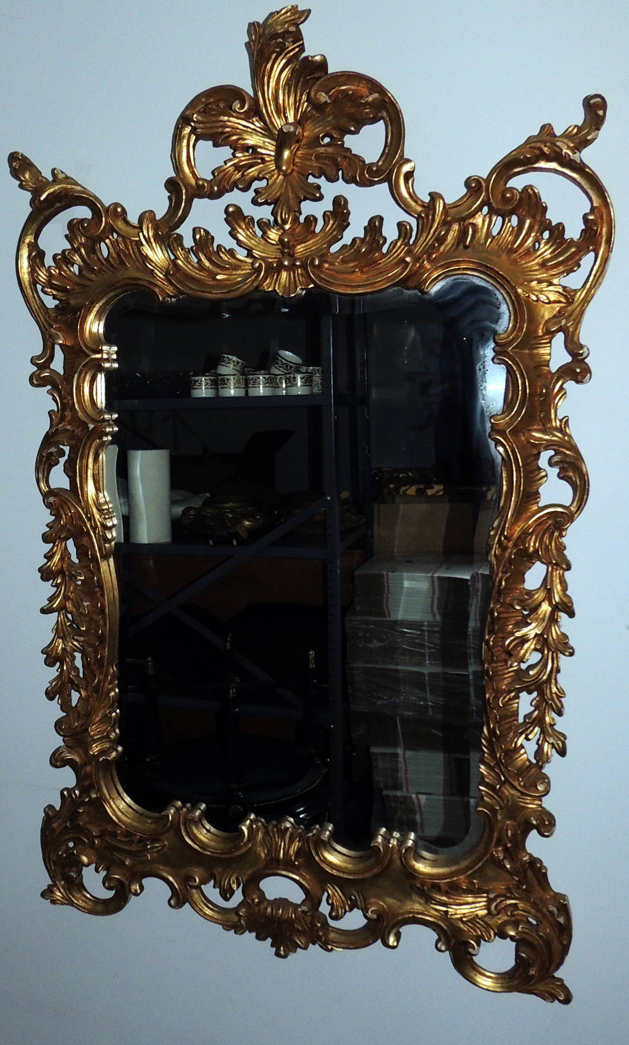 A wonderful pair of Italian gilt carved wood mirrors with beveled edges are sure to have a decorative impact on your special room. The hand-carved wood is beautifully detailed with decorative scroll and wonderful pierced work. The top crown is 15