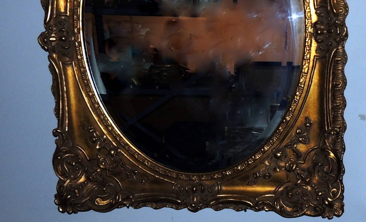Beveled Elegant Pair of Antique Oval Bevelled Regal Mirrors in Carved Giltwood Frame