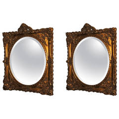 Elegant Pair of Antique Oval Bevelled Regal Mirrors in Carved Giltwood Frame
