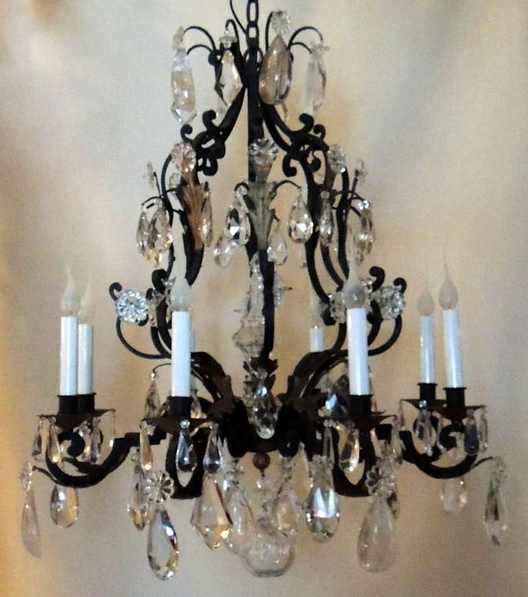 A Wonderful French wrought iron chandelier in the Louis XV style with gilt-tole foliate elements and many large and unusual crystal & Rock Crystals pendants & Centered With A large Odalisque
