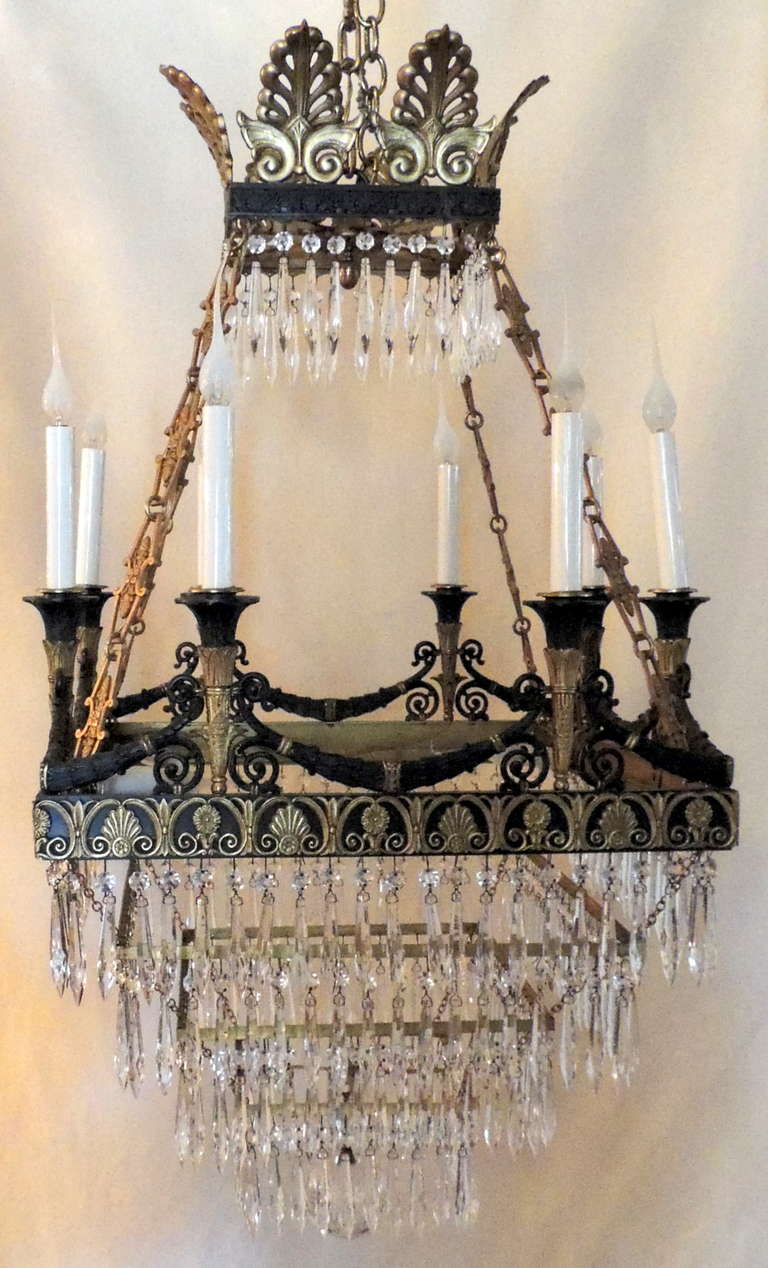A very fine 19th century square French Empire doré bronze and patinated chandelier adorned with crystal. This Baltic fixture is set with eight lights on the top gallery and four lights on the inside.
CH483.