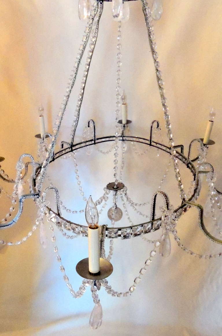 Wonderful vintage oval eight-light Mid-Century Modern transitional beaded and rock crystal Italian chandelier in the Baguès style. Done in an antique silver tone, decorated with cut crystal square panels around the oval frame and crystal swags and