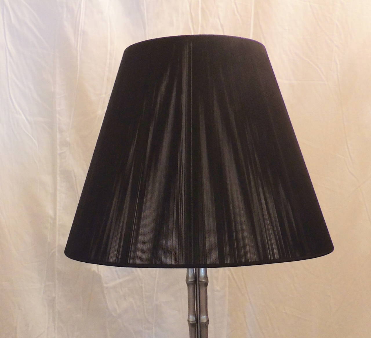 Beautiful re-silvered bronze faux bamboo styled lamp attributed to Maison Baguès, with wonderful unusual black fiber lampshade. Measure: A full 70