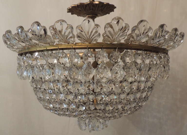 Beautiful Crystal & Bronze 3 Light Flush Mount Fixture.  There are crystal leaves surrounding the upper rim of the fixture, with tear drop crystals suspended from the rim.