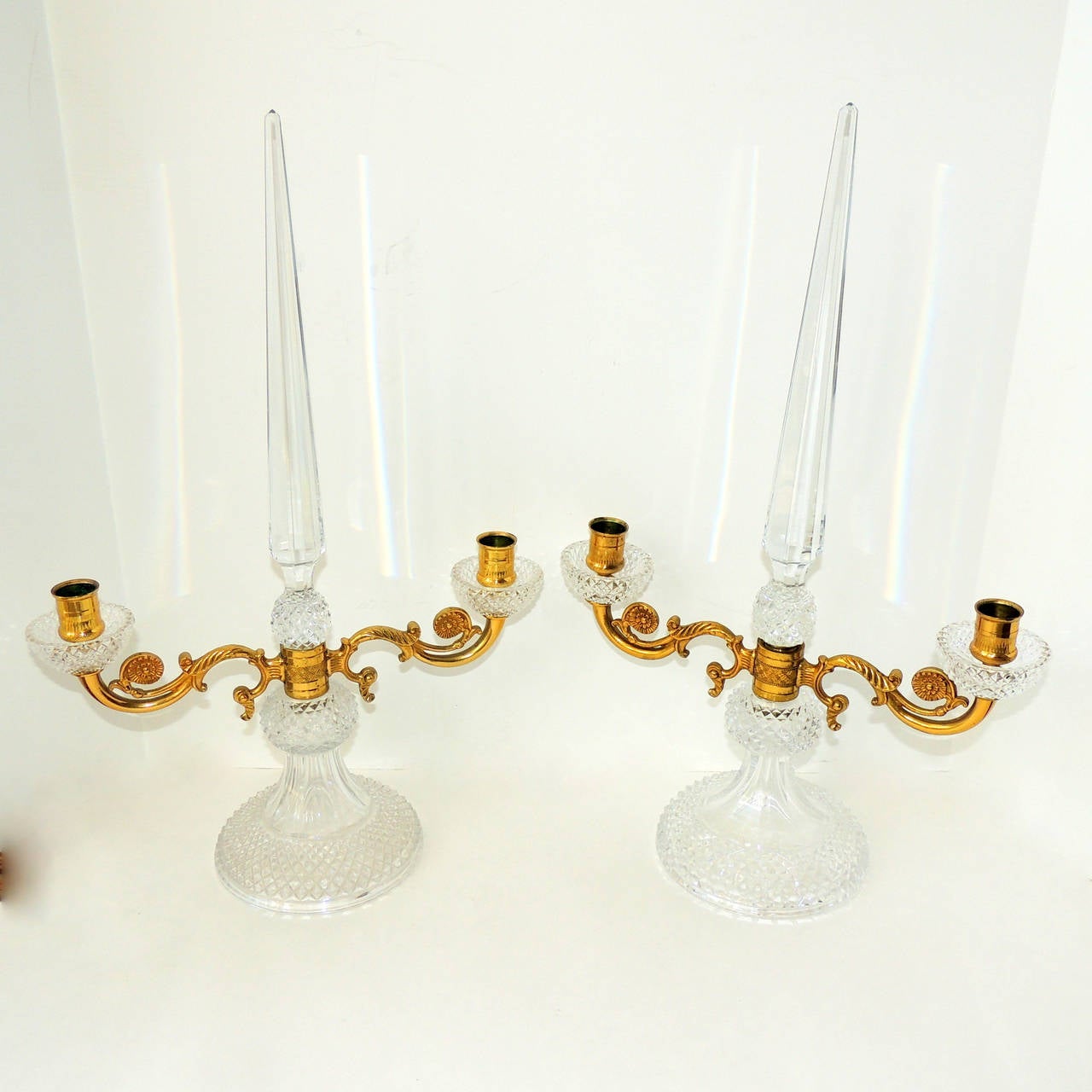 These elegant candelabras have a wonderful spire in the center and beautiful cut crystal that shimmers in the candlelight. The Doré bronze center is intricately decorated with scrolls accenting the arms. 

Measures: 19" H x 12" W on