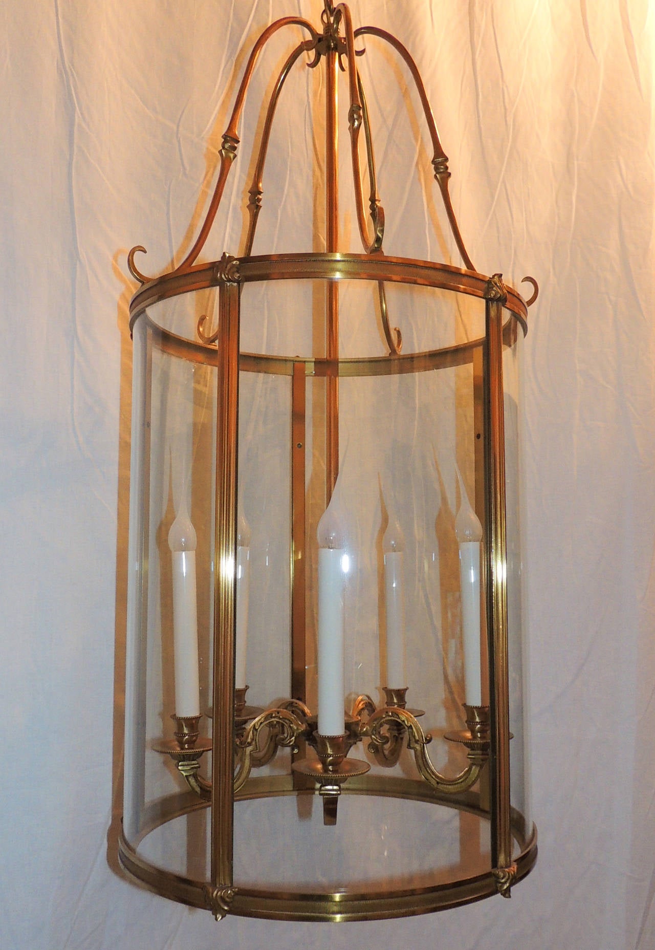 Elegant dore bronze five-light lantern with etched ribbed bronze trim on top and bottom of lantern and fluted trim around curved crystal panels.  Each of the 5 arms are decorated with beautiful scroll detail and scroll detail on the top crown.
