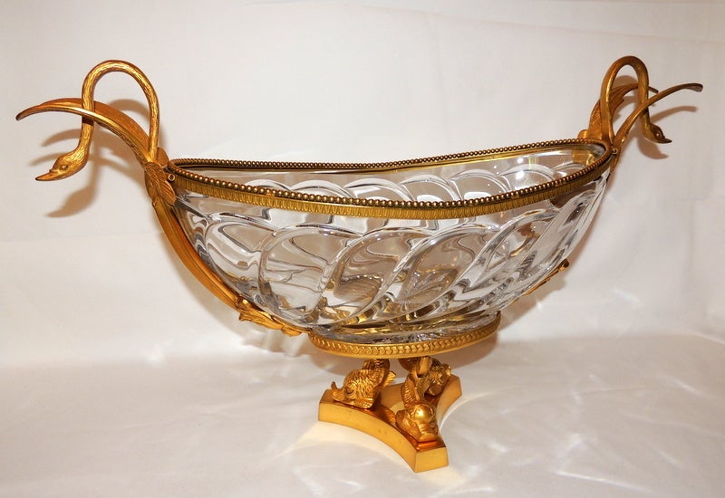 A Substantial & Very finely detailed, recently dored, bronze mounted centerpiece with swan handles and footed with 3 dolphins.  The cut crystal bowl is signed Martin CF Benito
