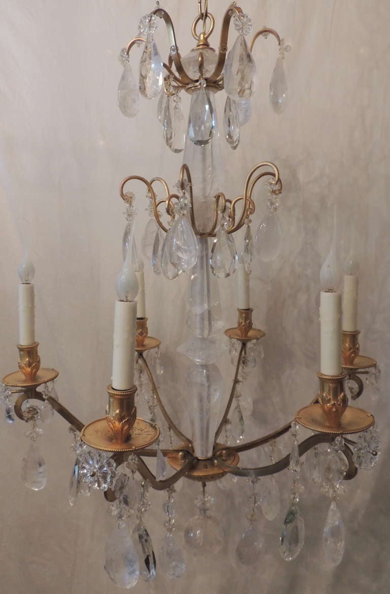 An unusual French doré bronze and rock crystal six arm chandelier. The centre shaft and all the other crystal parts to this amazing fixture are made up off rock crystal.