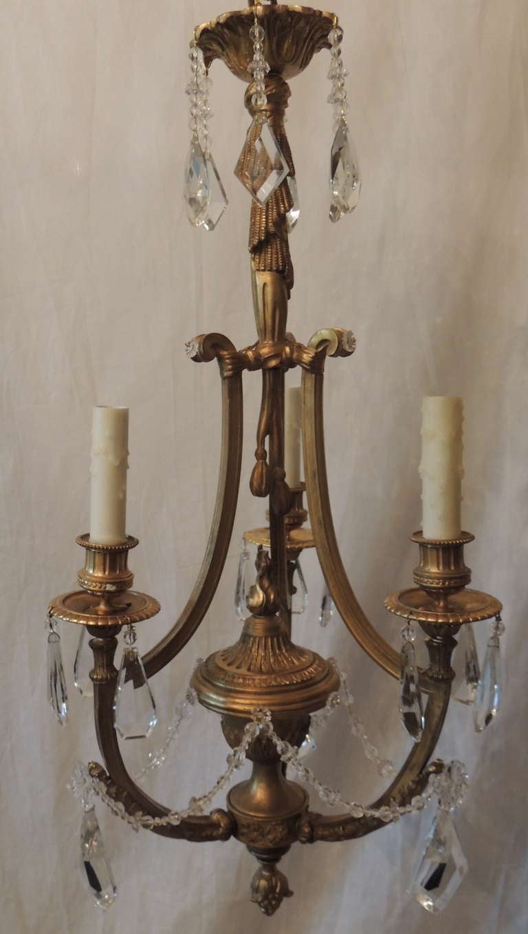 Very fine, beautifully detailed French doré bronze and crystal three-arm chandelier with flame top urn centre in the neoclassical style.